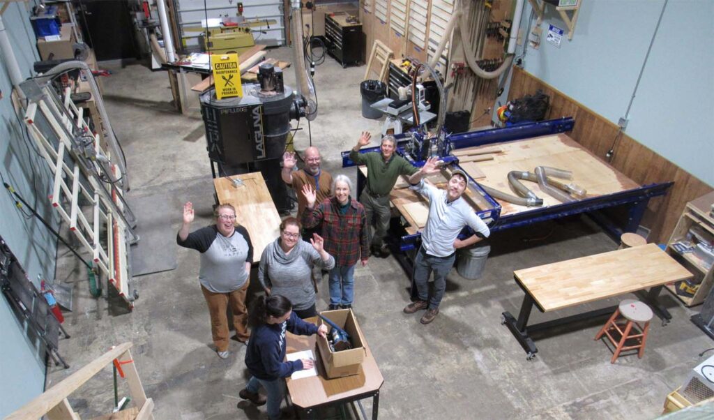 People excited on the floor of the makerspace
