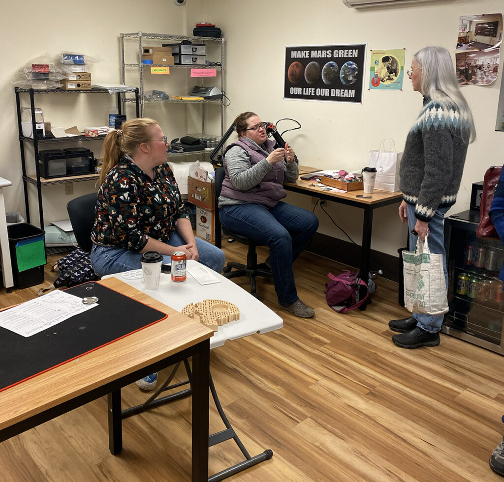 3D Printing Makerspace Room with people conversing.