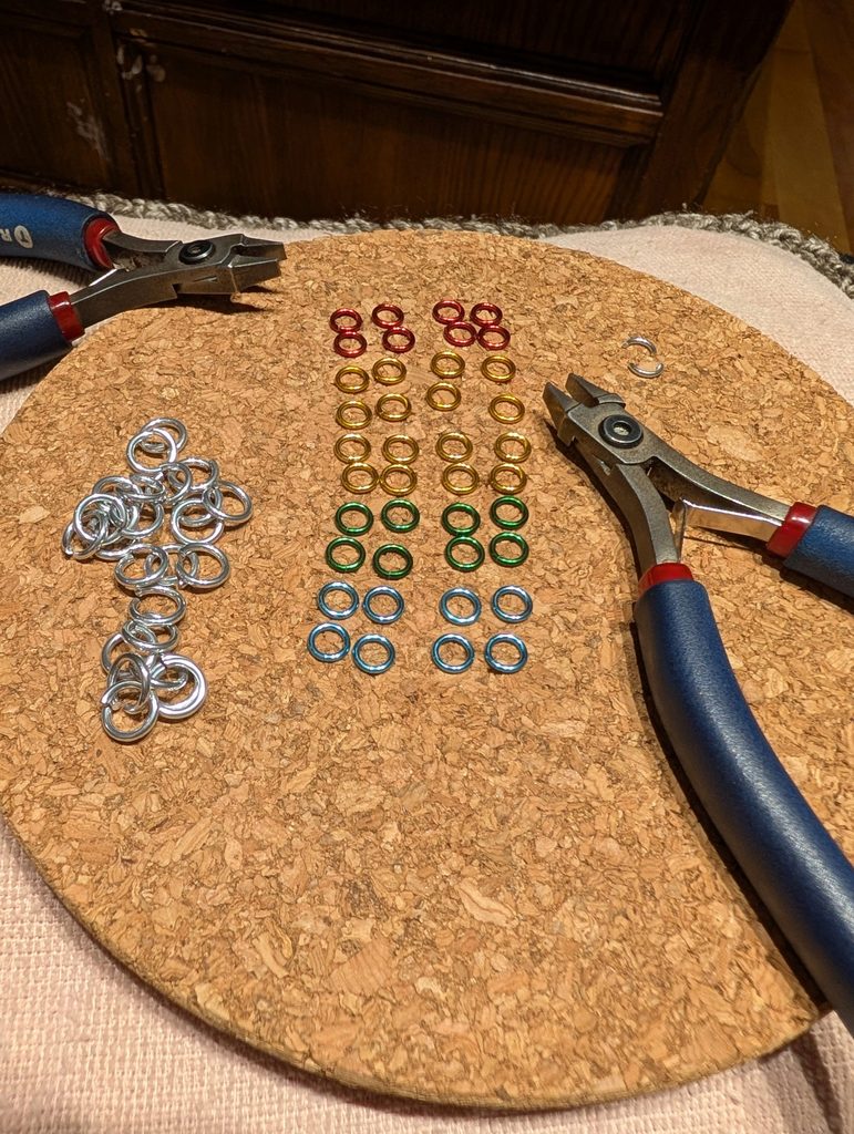 Pliers with metal rings of various colors.