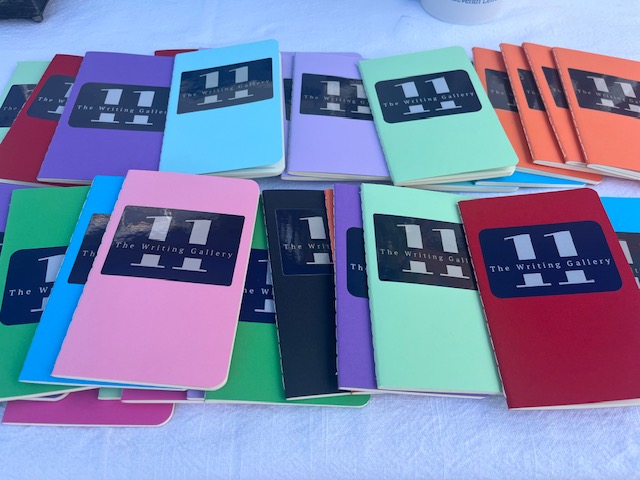 Writing journals with the The Eleventh Letter Writing Gallery logo.